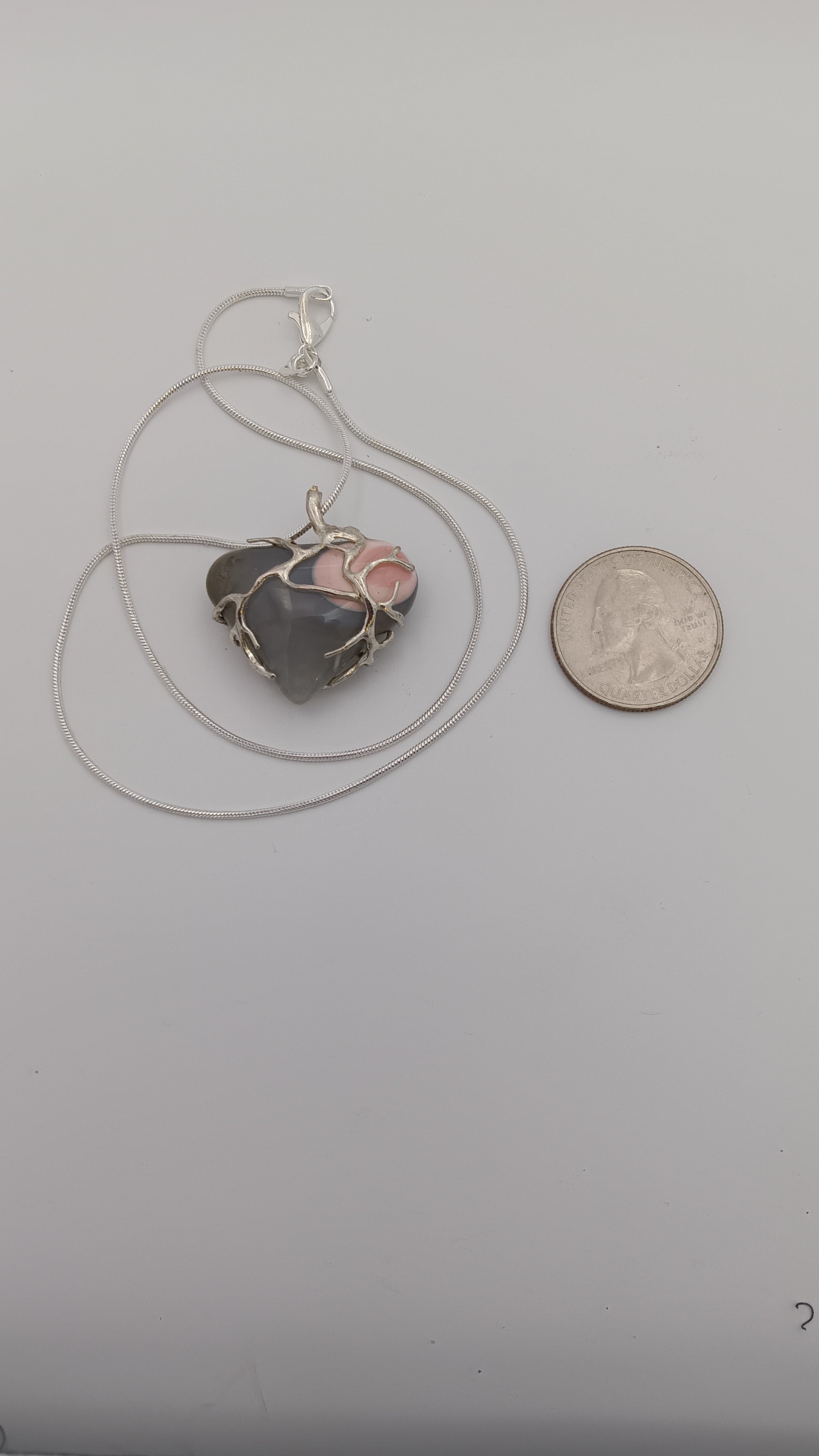 Thunderegg heart pendant size comparison with coin Jones Stones USA