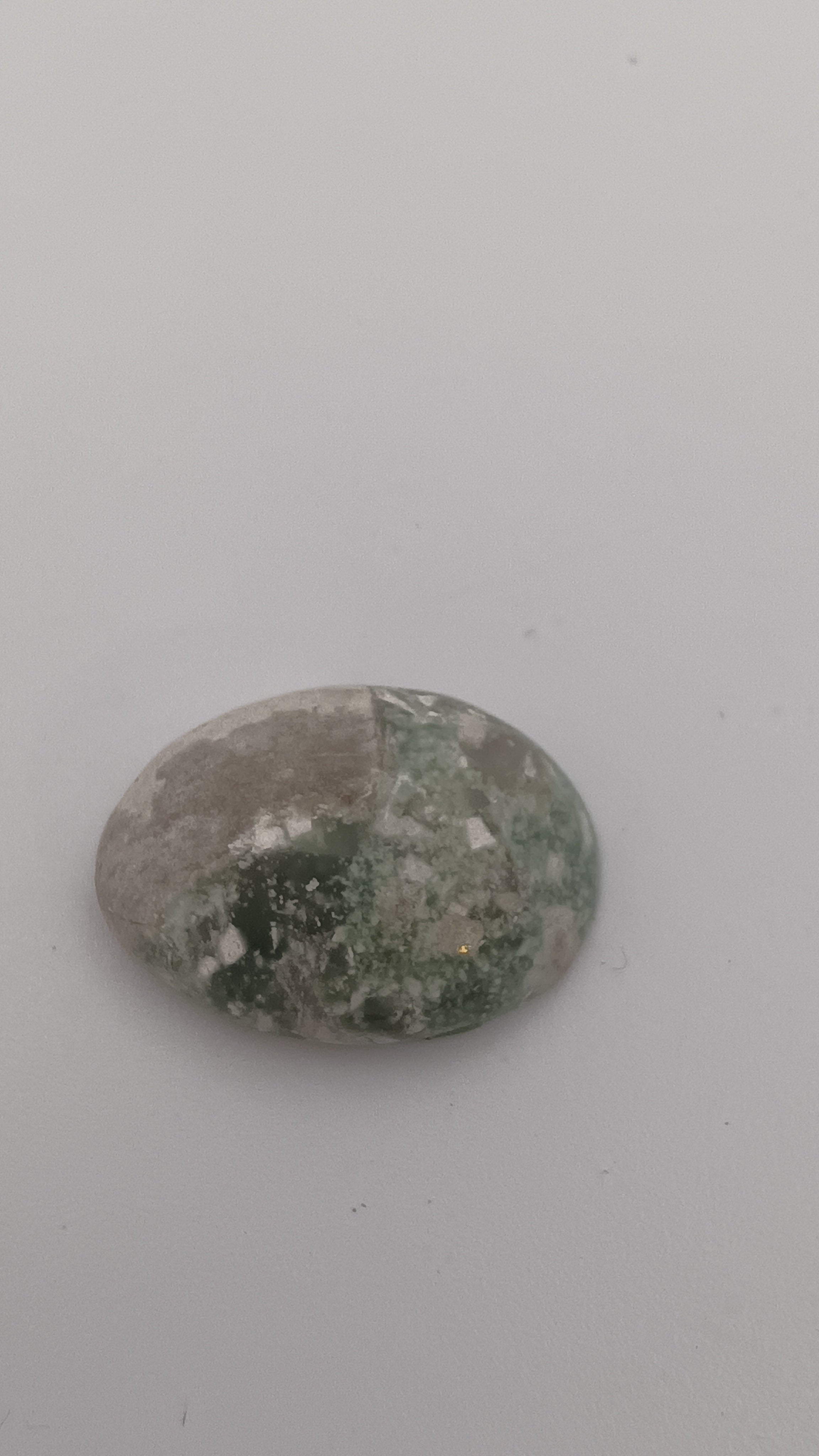 Green and white malachite oval side view showing natural banding pattern by Jones Stones USA