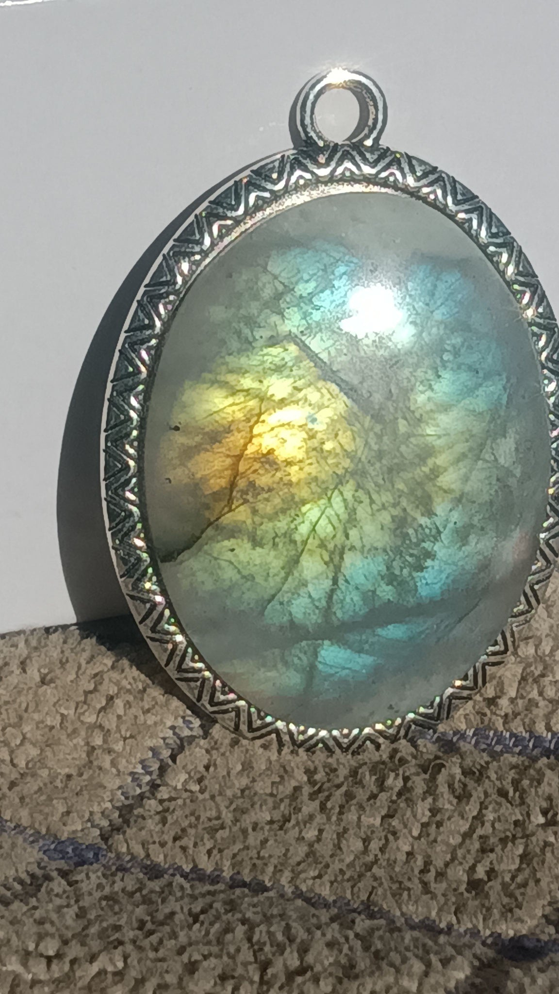 Dragon's Eye Labradorite freeform cabochon. Polished blue, gold, orange flash, dark pine tree pattern, brown inclusions. Handcrafted silver bezel one-of-a-kind gemstone pendant. Rockhound Studio.